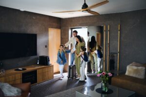 happy young family with two children enetring room at luxury hotel summer holiday.jpg